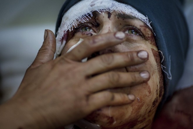 a-woman-named-aida-cries-as-she-recovers-from-severe-injuries-after-the-syrian-army-shelled-her-house-in-idlib-northern-syria-march-10-2012-aidas-husband-and-two-children-were-killed-in-the-attack.jpg